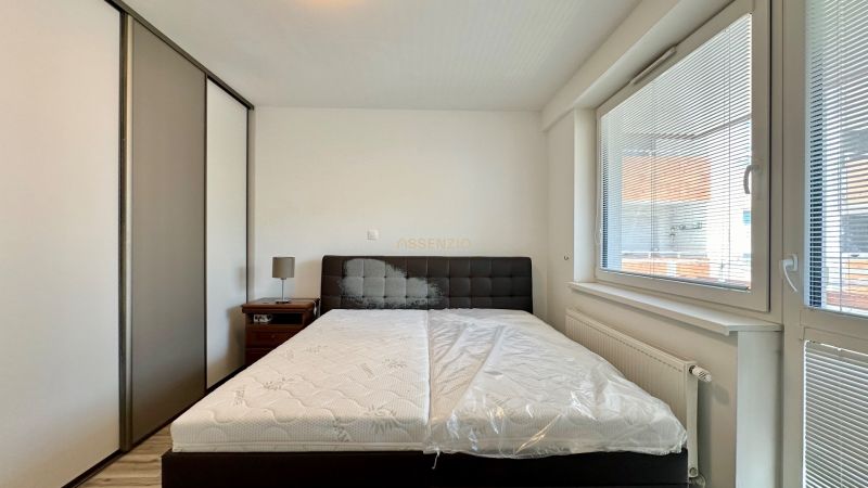 Bedroom in a 3-room apartment with a bed, built-in wardrobe, and nightstand.