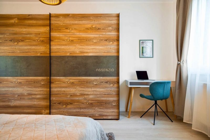 There is a desk, an armchair, and a wardrobe in the 2-room apartment.