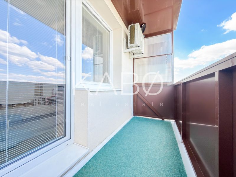 A balcony of a 2-room apartment in Nitra with a view of the sky and air conditioning.