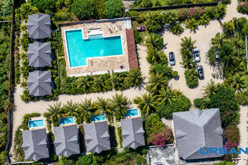 Aerial view of family houses in Pwani Mchangani with a pool and garden.