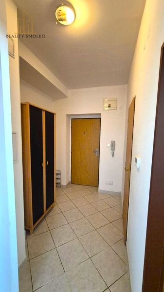 Entrance hallway in a one-bedroom apartment with tiles and a wardrobe.