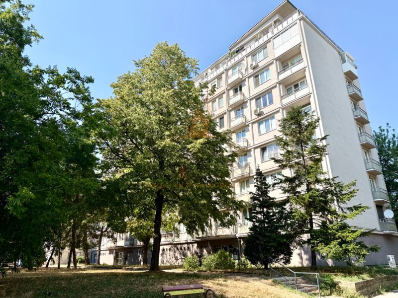 Apartment building on Piešťanská Street in Bratislava - Nové Mesto surrounded by greenery and a bench.
