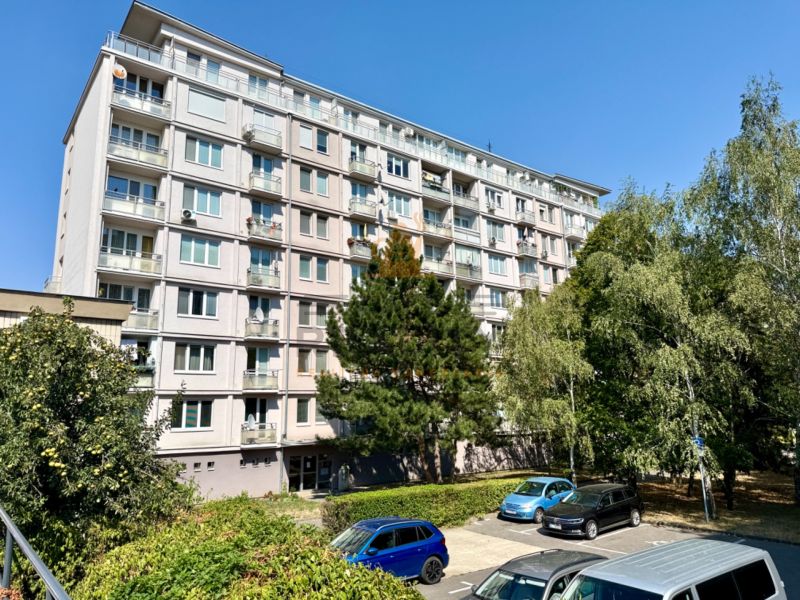 Apartment building on Piešťanská Street in Bratislava - Nové Mesto surrounded by greenery and a parking lot.