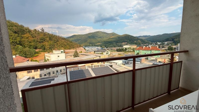 View from the balcony of a 4-room apartment in Nová Baňa to the mountains and buildings.