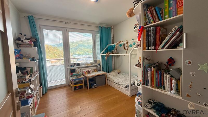 Children's room with a bed and shelves in a 4-room apartment, floor with wooden decor.