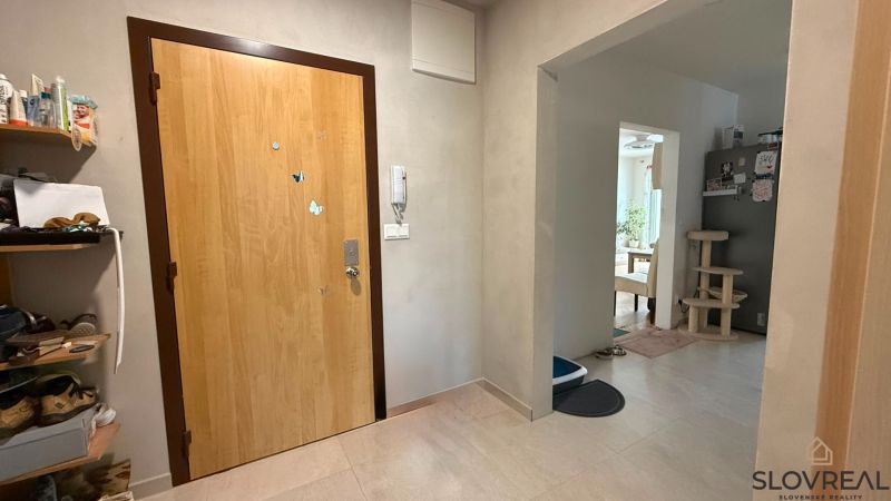 Entrance hall in a 4-room apartment with wood-patterned flooring, open entry to the room.