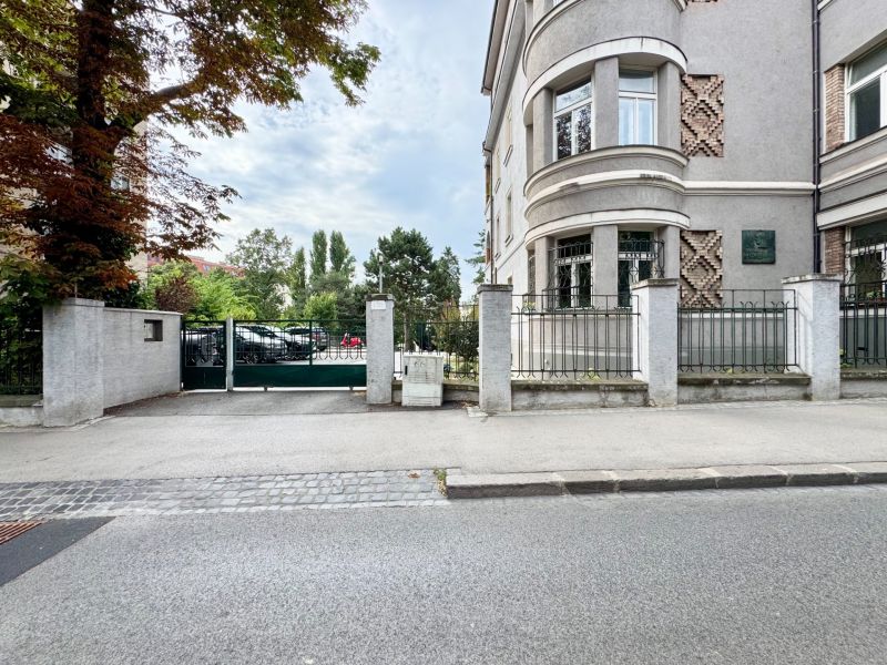 The building on Palisády in Bratislava - Old Town with decorative masonry and trees around.