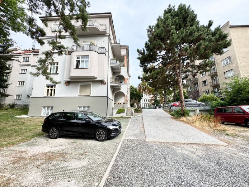 Apartment building near Palisády Street in Bratislava - Old Town, surrounded by greenery and cars.