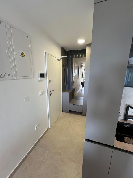 Entrance hallway in a 3-room apartment with minimalist design and tiling.