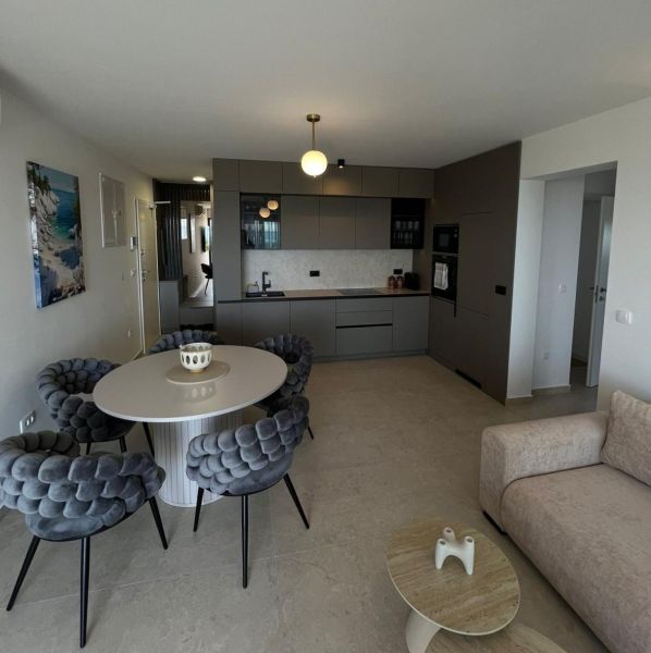 Stylish kitchen and dining room in a 3-room apartment with a large round table.