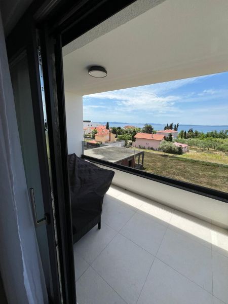 View from the balcony of a 3-room apartment in Privlaka, overlooking the sea and rooftops.