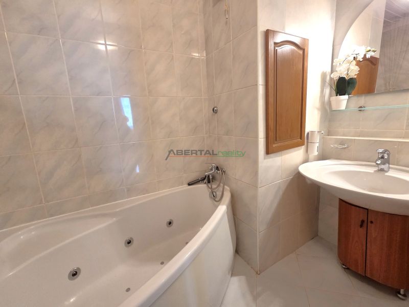 A bathroom with a bathtub and a sink in a 3-room apartment.