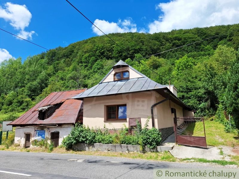 An old house with a sloped roof in Mýto pod Ďumbierom, surrounded by greenery.