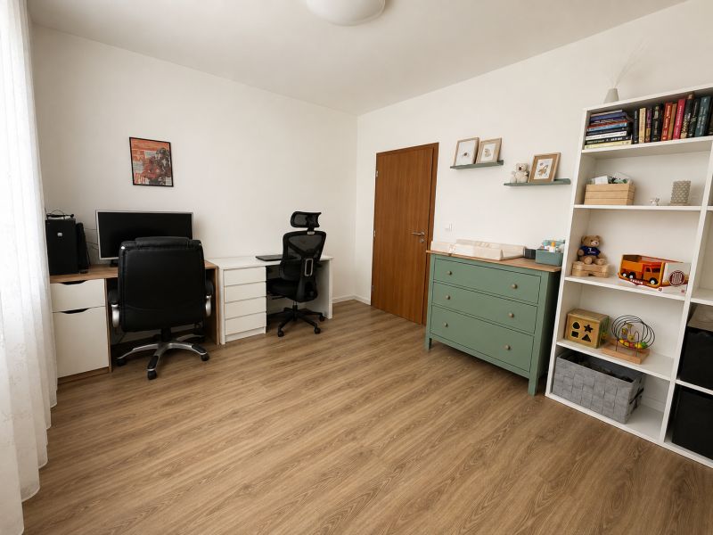 A home office in a 3-room apartment with a wood-patterned floor and storage space.