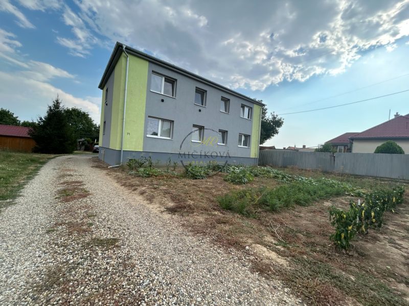 A two-story building with a garden and a road in Telince, suitable for a 2-room apartment.