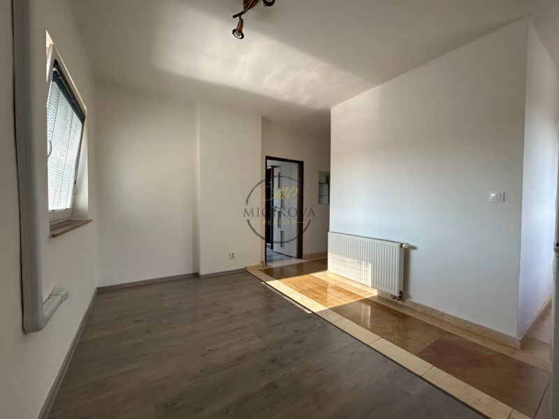 Interior of a 2-room apartment with a wooden decor floor and a radiator.
