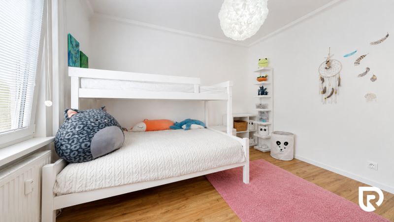 A children's room with a bunk bed and decorations in a 3-room apartment.