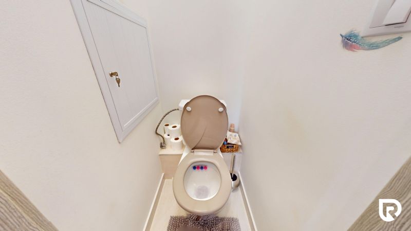 A bathroom with accessories and a cabinet in a 3-room apartment.