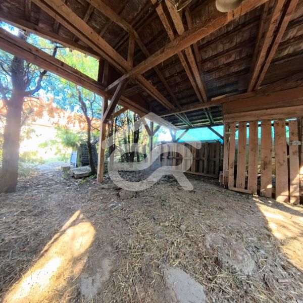 A wooden shelter in the garden of a family house on Školská Street in Tesárske Mlyňany.
