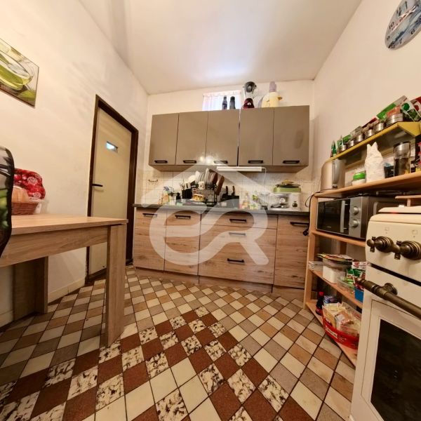 A kitchen in a family house with tiles and furniture in a wooden decor.