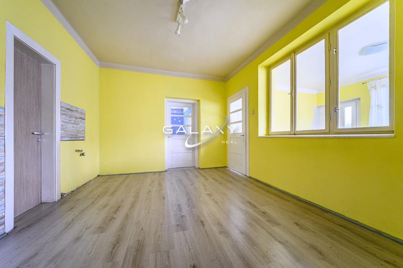 Yellow walls and a wooden decor floor in a family house.