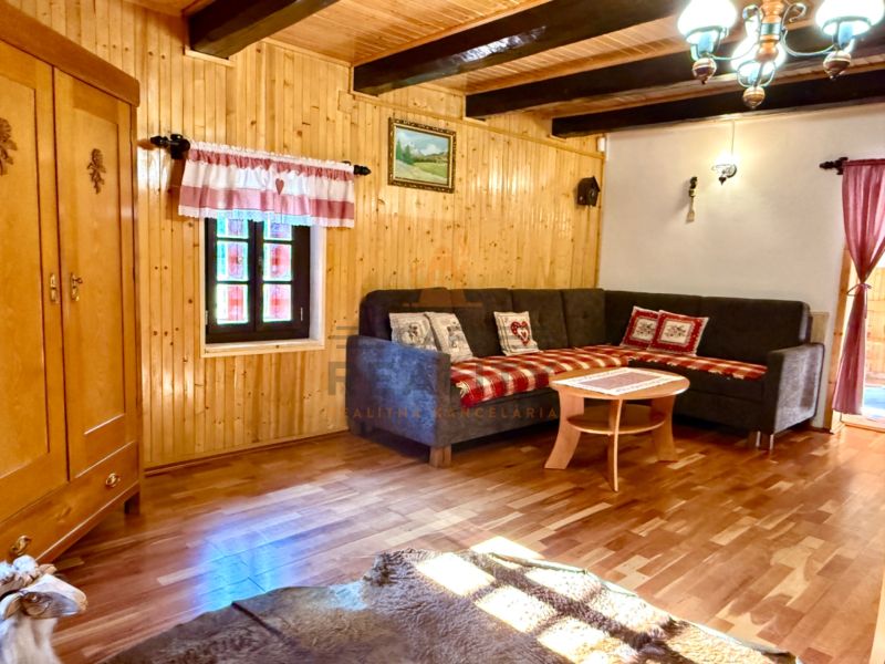Interior of a family house with a corner sofa, cabinet, and floor with wood decor.