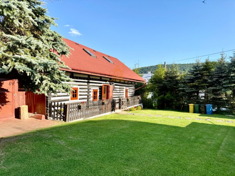 A family house on Jána Švermu Street in Šumiac, surrounded by greenery and trees.