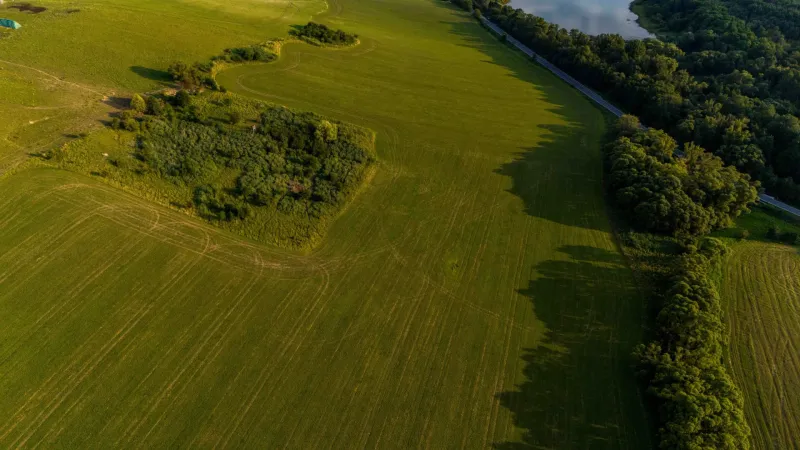 Aerial view of the green plains and forests around Liptovský Trnovec.