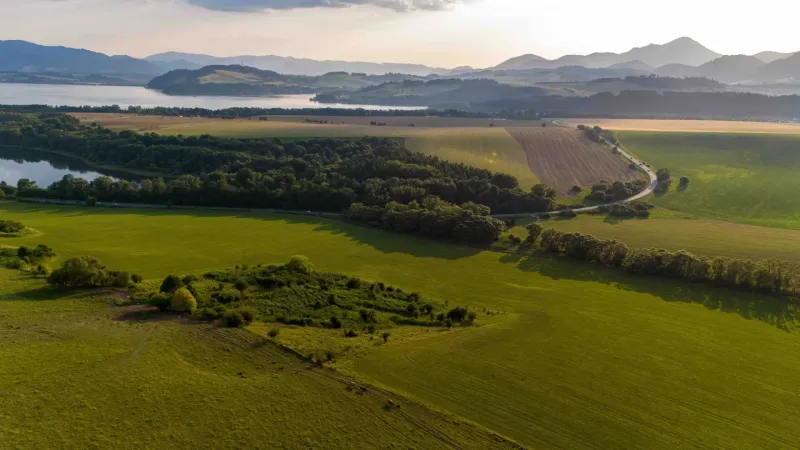 A landscape in Liptovský Trnovec with greenery, forests, and hills. Unique properties.