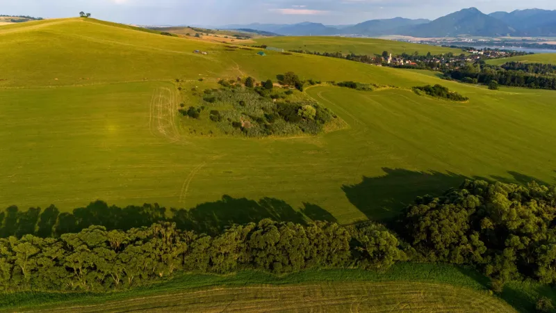 Green meadows and trees overlooking the village in Liptovský Trnovec, unique properties.