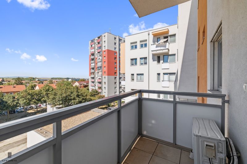 View from the balcony of a 3-room apartment on 1st May Square in Senec, with surrounding houses.