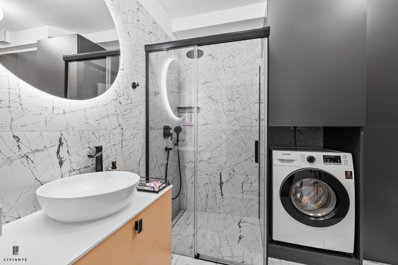 A bathroom in a 3-room apartment with marble tiles, a washing machine, and a shower.