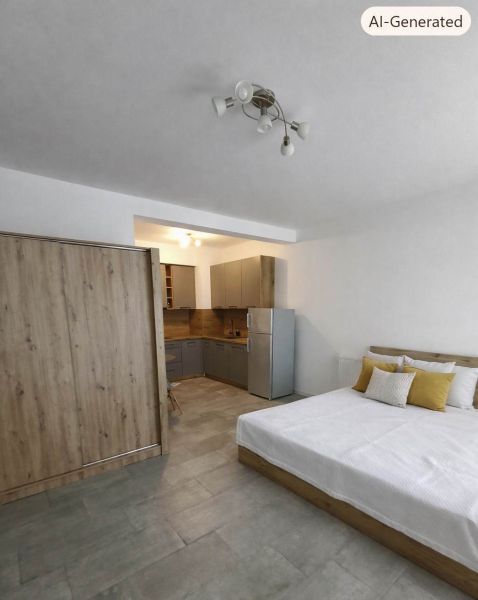 Bedroom in a studio apartment with a kitchen, wooden decor flooring, gray furniture.