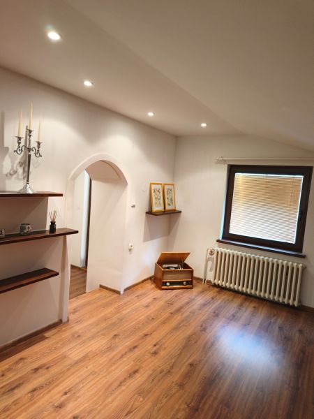 Interior of a family house with an arched entrance and a wooden decor floor.