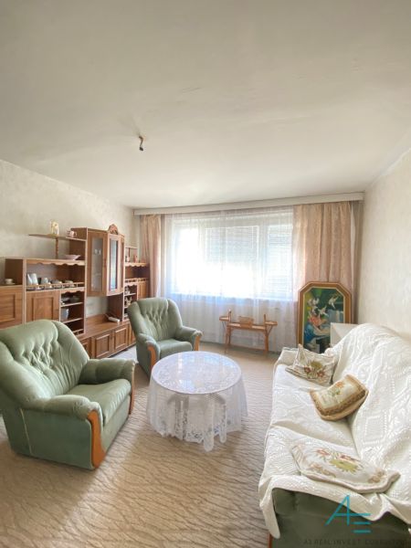 Living room in a 4-room apartment with a sofa, armchairs, and a furniture set.