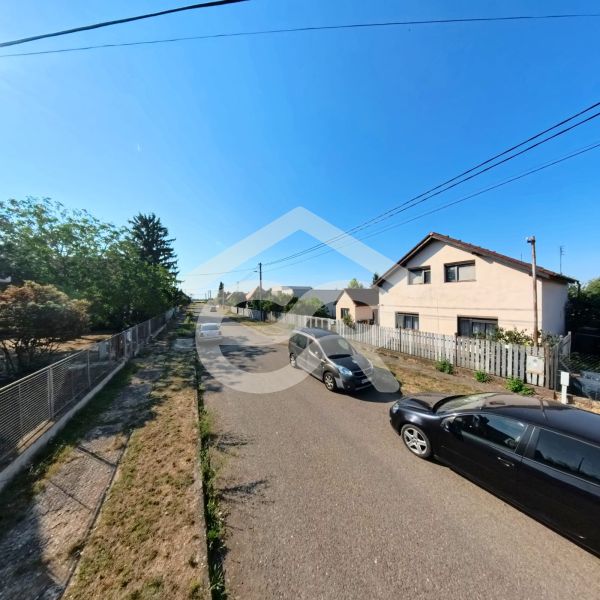 House on Prenosilova Street in Mojmírovce, next to the road with cars and fences.