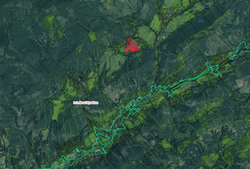 Aerial photograph of the Nová Bystrica landscape with agricultural and forest lands, highlighted area.