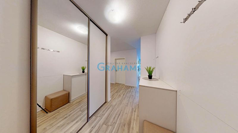 Hallway of a 3-room apartment with a wardrobe and a wooden decor floor.