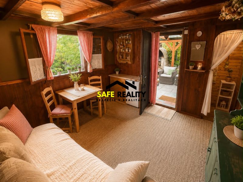 A cabin with a wooden interior, cozy furniture, and access to a veranda.