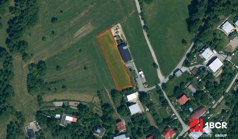Aerial photograph of agricultural and forest lands in Oščadnica with marked outline.