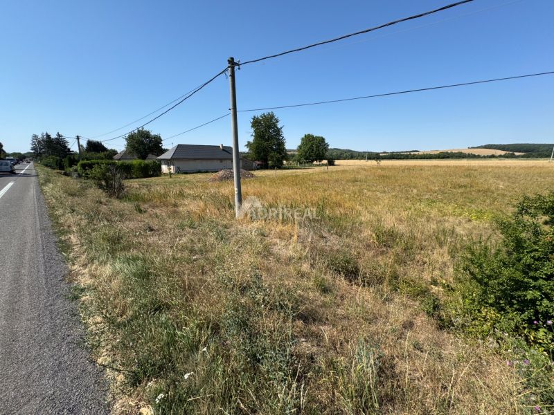 Residential plots in Hokovce with a view of the countryside and proximity to the road.