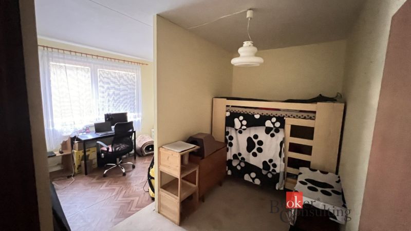 A children's room in a two-room apartment with a bunk bed and a work corner.