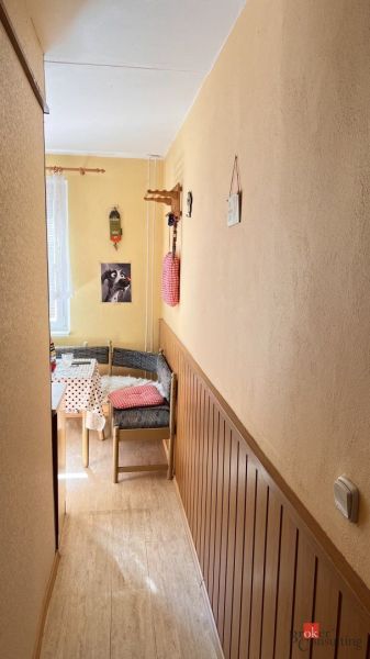 A cozy corner in a 2-room apartment with a wooden decor floor and colorful decorations.