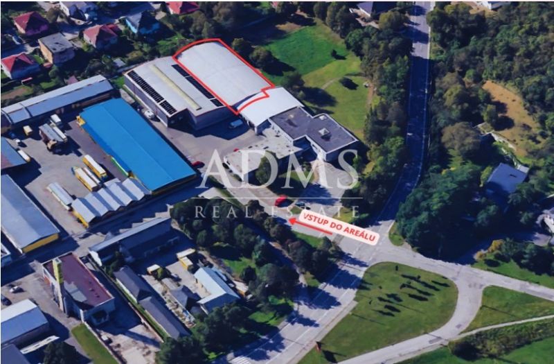 Aerial view of warehouses and halls in Žilina surrounded by greenery and buildings.