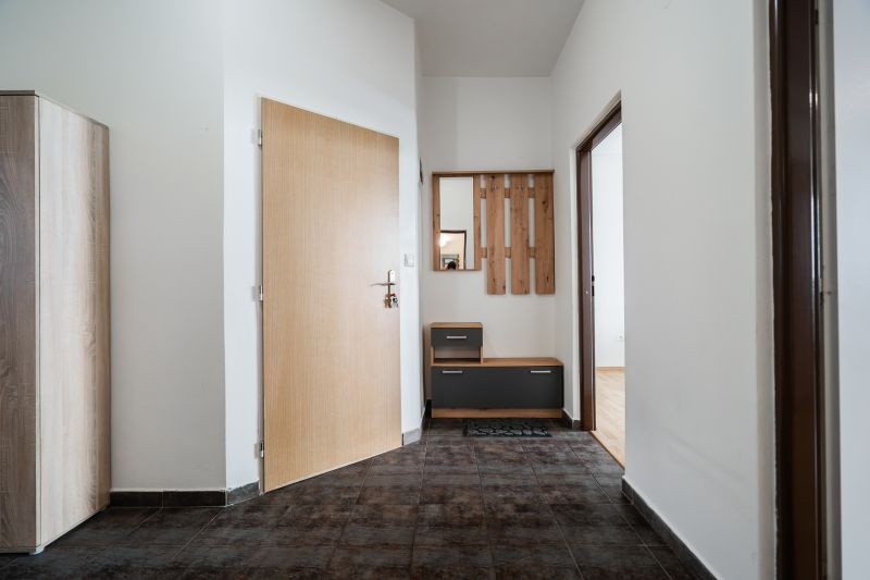 Entrance hallway in a 2-room apartment with practical furniture and ceramic flooring.