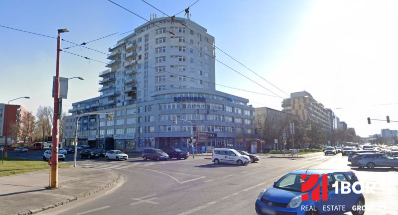 The building on Tomášikova Street in Bratislava - Ružinov, busy intersection and traffic.