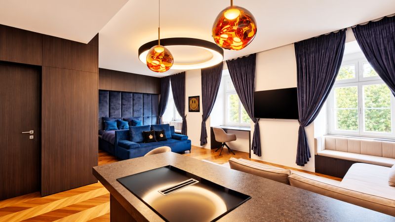2-room apartment with a velvet sofa, wooden decor, and lighting.