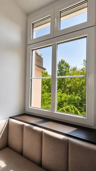 A bright room with comfortable seating and a large window, 2-room apartment.