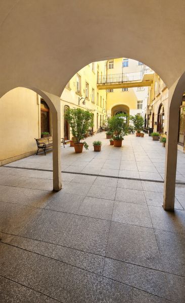 Arcade with arches and flower pots on Hviezdoslav Square in Bratislava - Old Town.