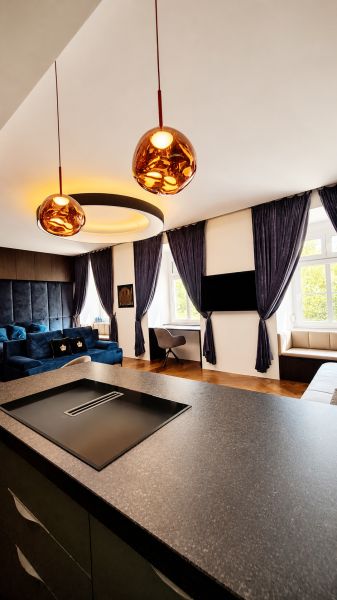 Interior of a 2-room apartment with built-in lighting, curtains, and flooring with a wooden decor.